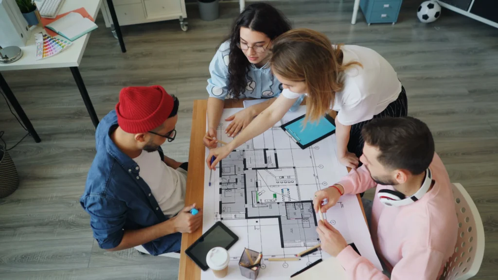 Project team reviewing a floor plan together around a meeting table