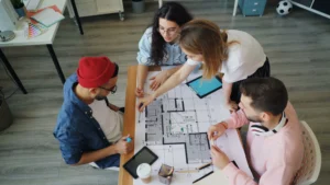 Project team reviewing a floor plan together around a meeting table